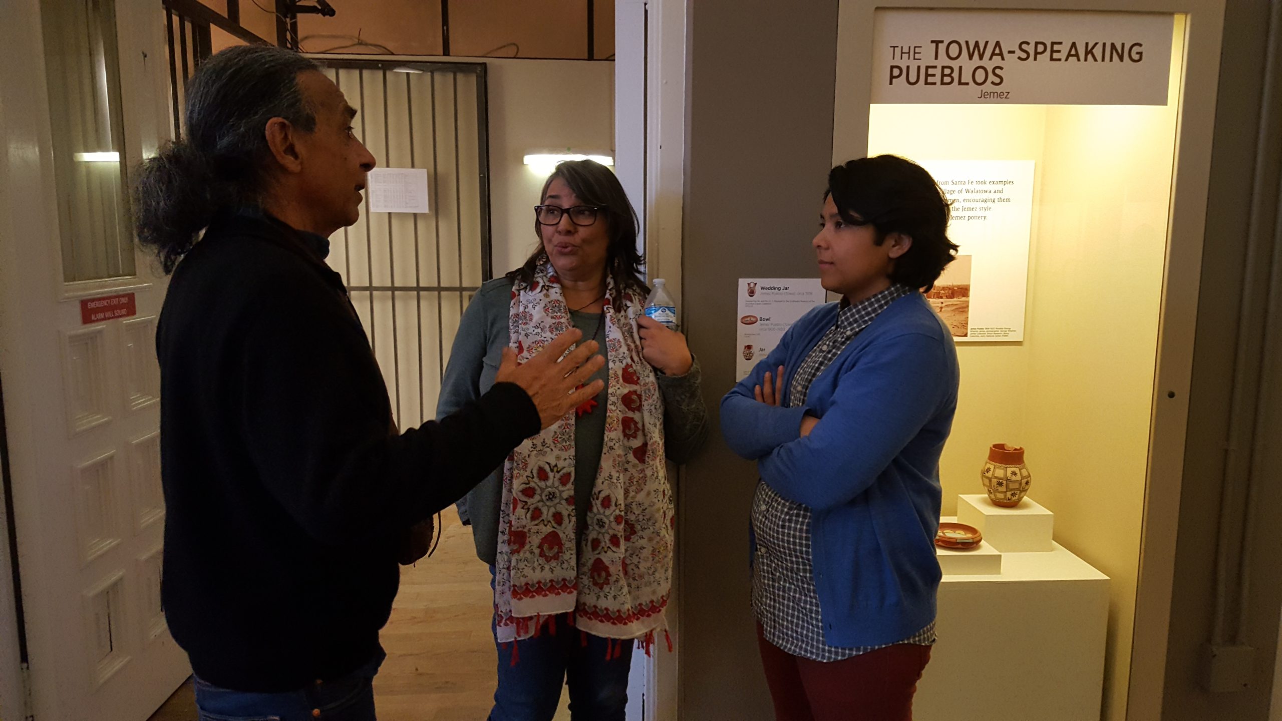 Three people talking at The Towa-Speaking Pueblos