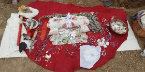 Tribal jewelry on a red blanket outside