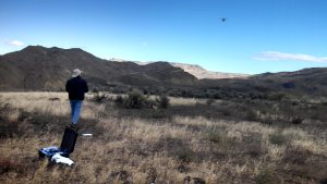 Man flying a drone over outdoor site
