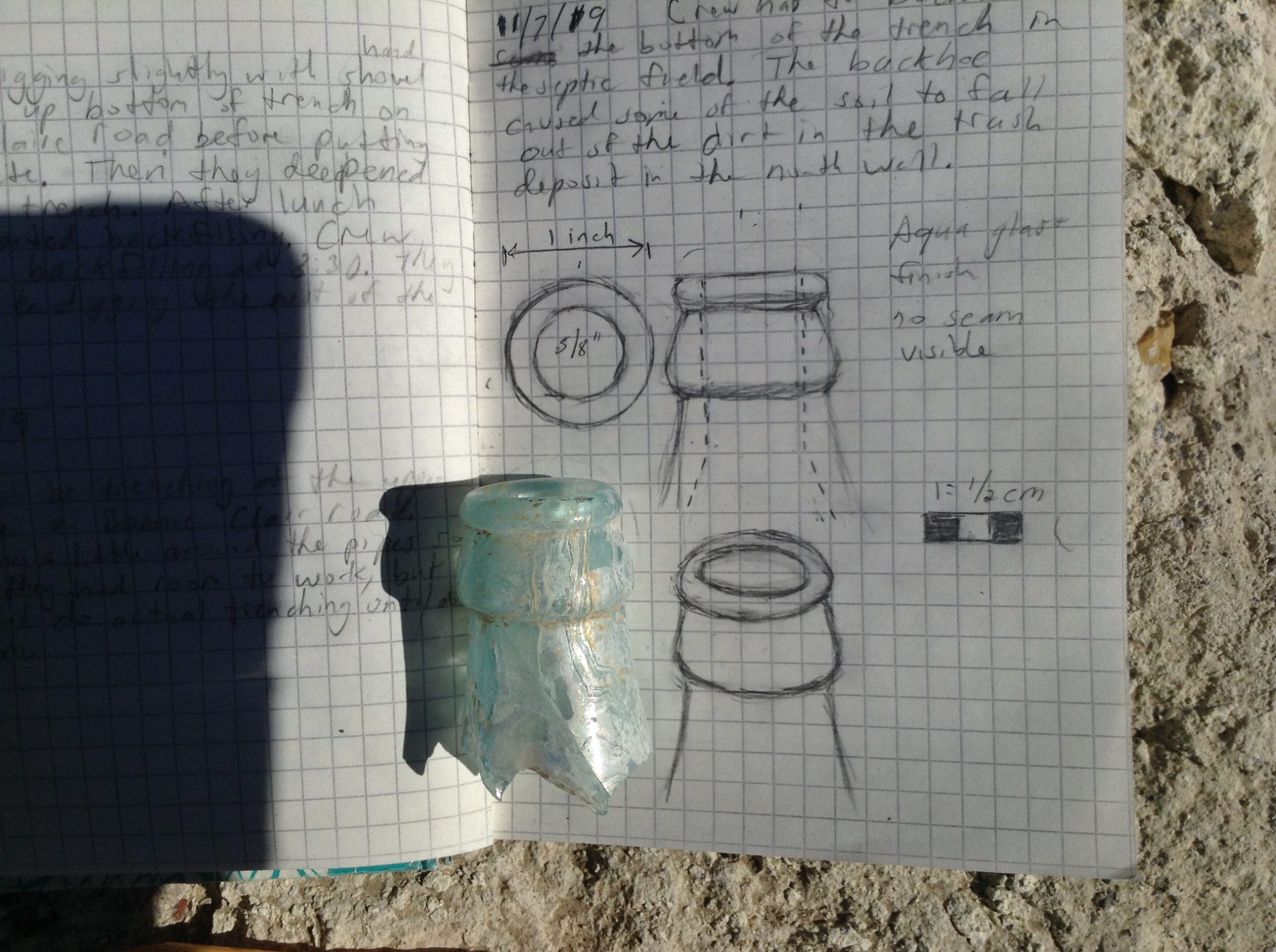 A found bottle fragment with related hand-written notes.