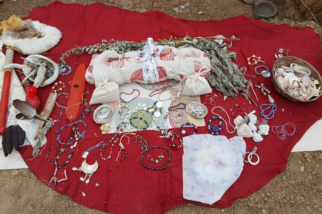 Tribal jewelry on a red blanket outside
