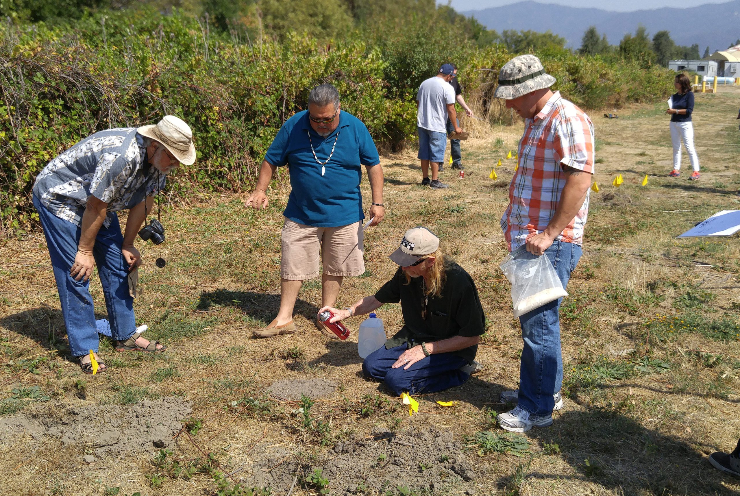 Four people assessing a natural site